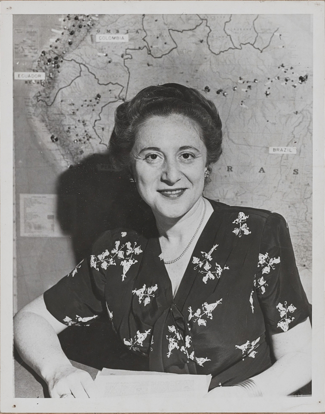 Photograph of Florence Arquin with a map of South America in the background.